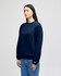 A navy blue crewneck sweatshirt with long sleeves, featuring a logo on one sleeve.