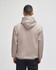 A beige pullover hooded sweatshirt with a loose fit and a hood, viewed from the back.