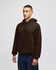 A brown pullover hooded sweatshirt with a front pocket and a logo, displayed on a model against a plain background.