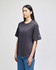 A dark grey Champion Adult Heritage Jersey T-Shirt with a loose fit, featuring a logo on the sleeve.
