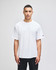 A white Champion Adult Heritage Jersey T-Shirt displayed on a model against a plain background.
