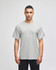 A grey short-sleeve t-shirt featuring a logo on the sleeve, displayed on a model.