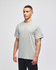 A grey Champion adult short-sleeve T-shirt displayed on a model. The shirt features a logo on one sleeve.