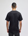 A black adult short-sleeve t-shirt with a plain back view, featuring a logo.