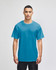 A short-sleeve t-shirt in a bright blue colour, featuring a logo, worn by a person standing against a neutral background.