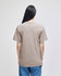 A plain beige adult short-sleeve t-shirt with a relaxed fit, viewed from the back.