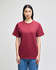 A maroon Champion adult short-sleeve t-shirt displayed on a model, featuring a logo on the sleeve.