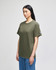 An olive green short-sleeve t-shirt displayed on a model with straight black hair, featuring a logo on the sleeve.