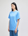 A light blue short-sleeve t-shirt displayed on a model, featuring a logo on the sleeve.