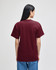 A short-sleeve t-shirt in maroon, viewed from the back, featuring a plain design and a logo.