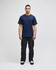 A navy blue Champion adult short-sleeve T-shirt displayed on a male model, paired with black pants.