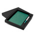 A green notebook with a matching pen, packaged in a black gift box.