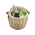 A wicker cooler basket in natural colour, filled with snacks, grapes, a drink bottle, and a magazine. It has leather handles.