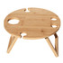 A circular bamboo picnic table with four drink holders and wooden legs, featuring a natural finish.
