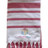 A striped Turkish beach towel in red and white, featuring tassels and a logo at the bottom.