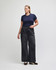 A fitted navy blue women's crop t-shirt paired with high-waisted black wide-leg jeans.