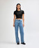A black crop fitted T-shirt paired with light blue wide-leg jeans, displayed on a model against a plain background.