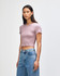 A cropped fitted t-shirt in mauve, featuring short sleeves and a round neckline, paired with high-waisted denim jeans.