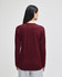 A long-sleeve t-shirt in burgundy, featuring a simple design and a logo on the back.