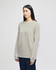 A long-sleeve t-shirt in light grey, featuring a branding logo, styled on a model against a neutral background.