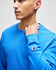 A blue Champion adult long-sleeve t-shirt worn by a person, featuring a small logo on the sleeve.