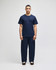 A navy blue short sleeve t-shirt displayed on a model, paired with matching navy pants, featuring a logo on the shirt.