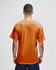 A back view of an adult jersey short sleeve T-shirt in orange, featuring a logo.