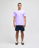 A purple short sleeve t-shirt on a model, paired with navy shorts, featuring a brand logo.