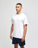 A white short sleeve t-shirt displayed on a model, featuring a logo on the sleeve, paired with navy shorts.