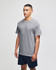 A grey short sleeve t-shirt with a logo, worn by a model, paired with navy shorts.