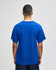 A blue Champion Adult Jersey Short Sleeve T-Shirt displayed from the back, featuring short sleeves and a simple design.