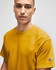 A mustard yellow Champion adult jersey short sleeve T-shirt with a logo on the sleeve.