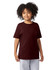 A young person wears a maroon short sleeve t-shirt with a simple design and a logo on the sleeve.