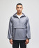 A grey packable anorak jacket with a hood, featuring a front pouch pocket and adjustable drawstrings.
