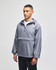 A grey packable anorak jacket features a hood, half-zip front, and a logo on the chest. Suitable for rain protection.
