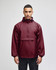 A maroon packable anorak jacket with a hood, featuring long sleeves and a front pocket. Includes a logo.