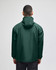A green packable anorak jacket with a hood, viewed from the back. The jacket has a logo on the back.