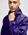 A purple packable anorak jacket with a logo, featuring a high collar and adjustable drawstring.