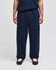 Navy open-bottom fleece pants with pockets, featuring a logo, displayed on a model.