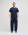 A model wears navy Champion Powerblend® adult open-bottom fleece pants with pockets, paired with a matching t-shirt.