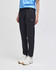 Black fleece jogger pants with an elastic waistband, featured alongside a blue top and white shoes.