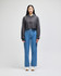 A cropped hoodie in grey with a hood, paired with high-waisted denim jeans and white shoes.