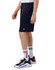 Navy sports shorts made of mesh, featuring pockets and a logo, displayed on a model with sporty shoes and socks.