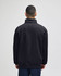 A black quarter-zip pullover with a high collar and a relaxed fit, featuring a logo on the back.
