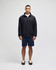 A model wearing a black Champion Powerblend® quarter-zip pullover and navy shorts, standing against a plain background.