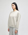 A light grey women's crewneck sweatshirt with a relaxed fit and a small logo on the sleeve.