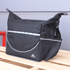 A black cooler bag with reflective accents and a logo, featuring a large front pocket and adjustable straps.