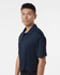 A man models a navy blue polo shirt featuring a collar and short sleeves, with a visible logo.