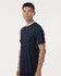 A man wearing a navy men's performance T-shirt, featuring a relaxed fit and minimal design.
