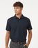A navy blue men's polo shirt with a collar and short sleeves, featuring a logo.